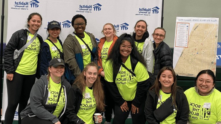 Photo shows the smiling face of 11 OT students who were volunteering with Habitat For Humanity.