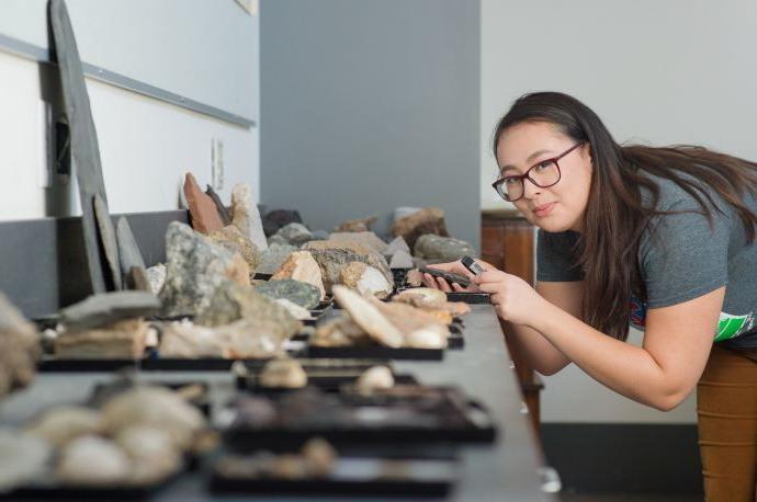 Student studying rocks in classroom